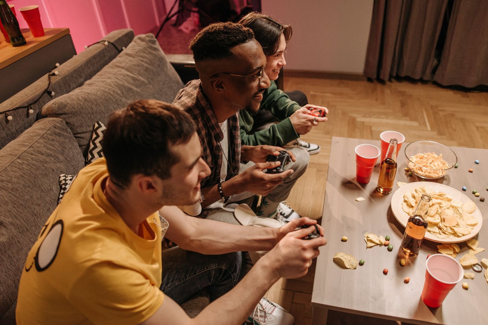 Group of friends playing video games and enjoying snacks indoors. — Exploring Real-Time Reactions in Live Casino Games